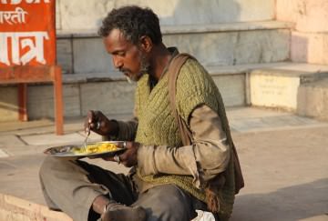 A homeless man having a meal