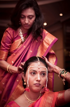 Aunt adding finishing touches to a bride's makeup