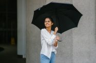happy-woman-holding-umbrella