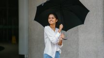 happy-woman-holding-umbrella
